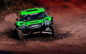 green rally car on red track
