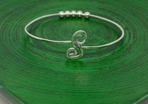 silver bracelet on green background