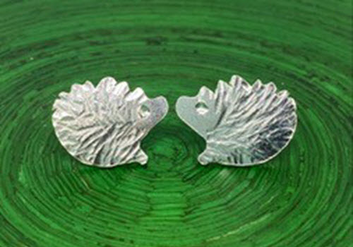 silver hedgehogs on green background