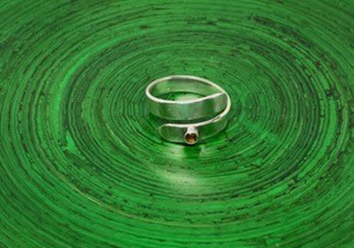 silver ring on green background