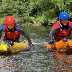 2 people on river bugs on river