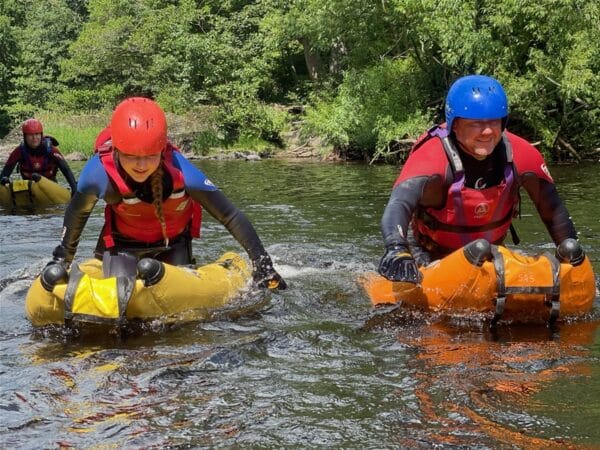 2 people on river bugs on river