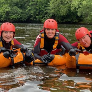 3 people on river bugs on river